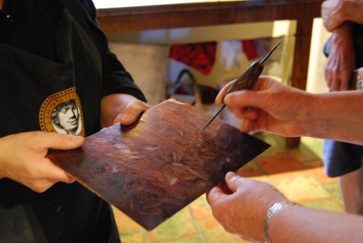 A visitor tries their hand at historic etching techniques at Rembrandt's House Museum.